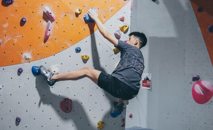 A young man bouldering