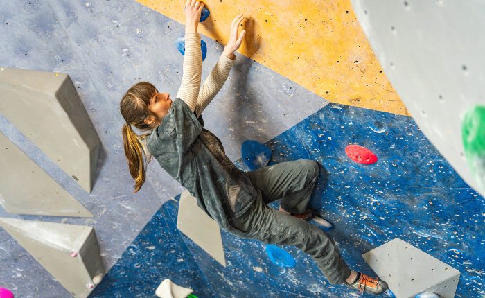 Women climbing on an indoor bouldering wall
