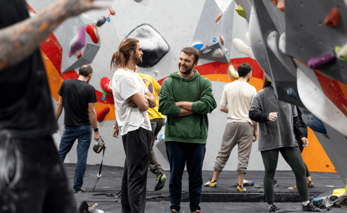 Climbers chat and laugh in between climbs on the mats