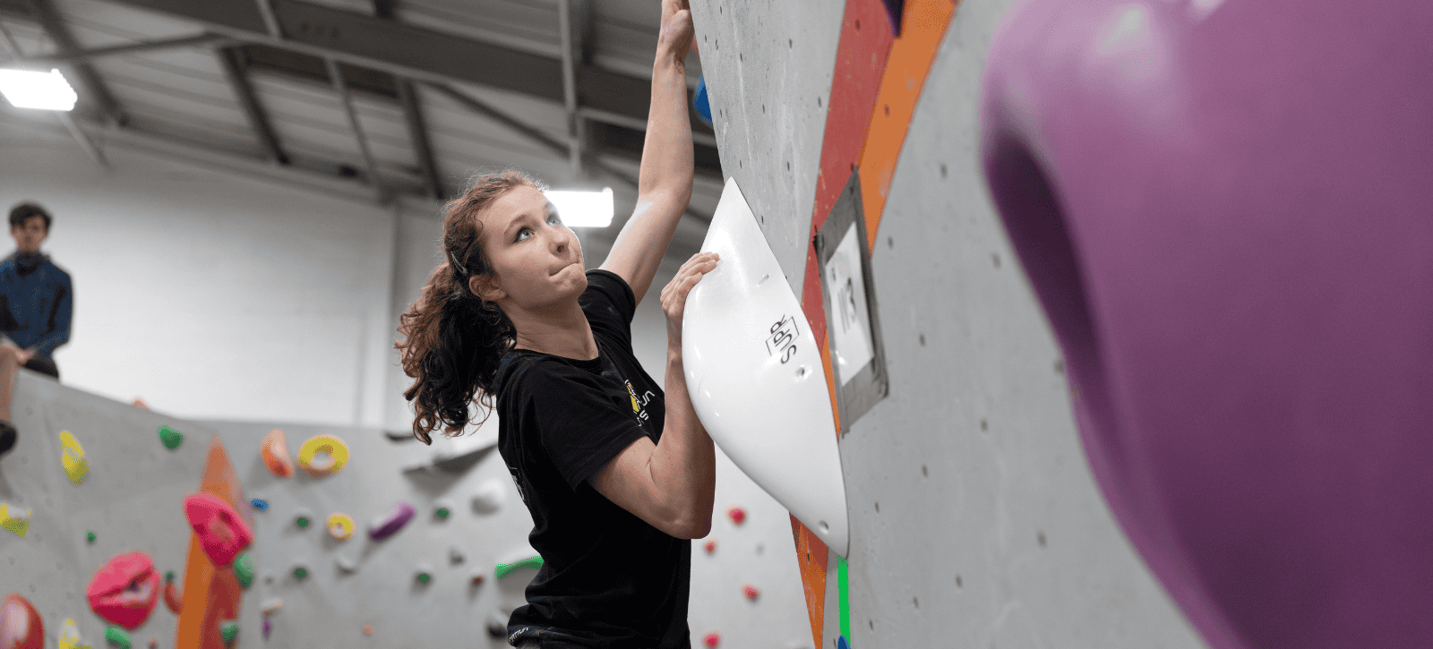 A climber looks up - ahead to their next move