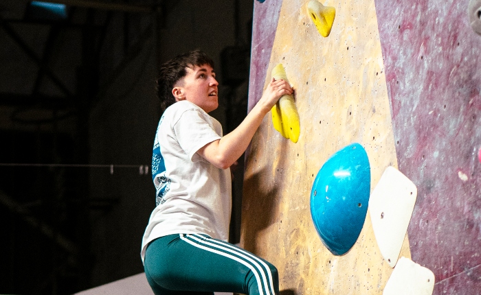 Person climbing at Queer Climbing Social at TCA